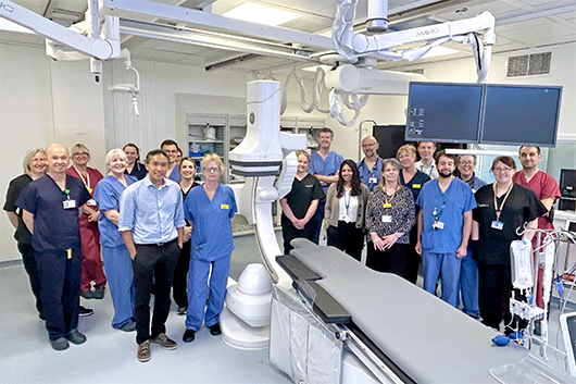 The Cardiology team standing in the new Cath Lab surrounded by state-of-the-art equipment
