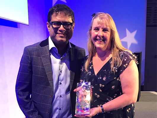 Karen Read receiving her award from Paul Sinha