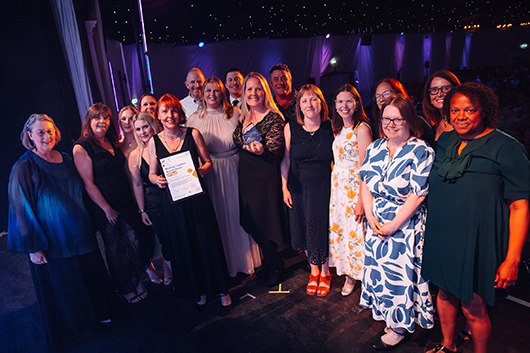 The Hospital at Home team at the award ceremonly posing with their award
