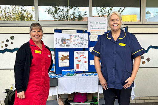 Infection control nurses at their stall with information about our gloves off campaign