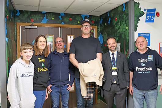Greg Davies standing outside the Children's Ward in a group shot that includes Time Is Precious founders Nicky and Neil Halford, and RUH Managing Director John Palmer